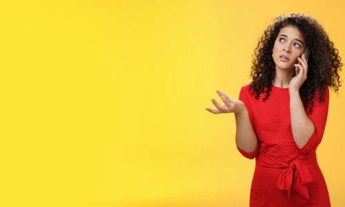 Lifestyle. Concerned and sad female friend telling details of bad situation happened on mobile phone discussing upset things with unhappy face gesturing with raised hand holding smartphone pressed to ear.